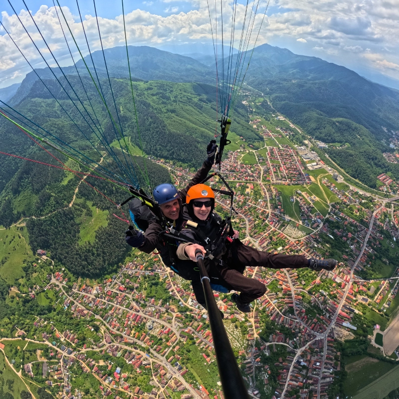 Point of view paragliding over Brasov and the Carpathian Mountains