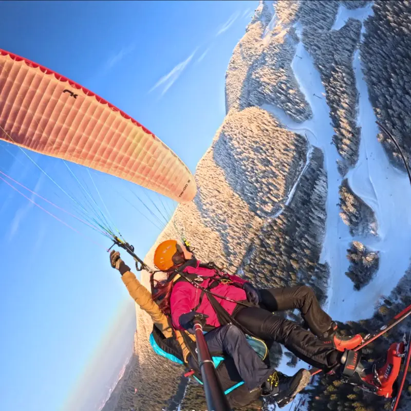 Point of view paragliding over Brasov and the Snowy Carpathian Mountains